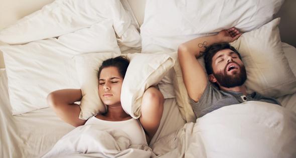 Snoring can be − but isn't always − a symptom of sleep apnea.  PeopleImages/iStock via Getty Images