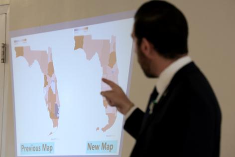 Oliver Larkin, Democratic candidate for Congress in Florida’s 23rd district, speaks during an emergency town hall that he held to address Florida Republicans’ newly approved congressional redistricting map (seen on wall) on May 4, 2026, in Coral Springs, Florida. The new redistricting map will affect who could potentially vote for Larkin. Florida Gov. Ron DeSantis announced he signed a redistricting bill that could help Republicans pick up four more House seats. A lawsuit was filed against the bill, contending that the governor and the Florida Legislature violated voter-approved anti-gerrymandering standards. (Joe Raedle/Getty Images/TCA)