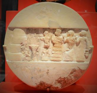 An ancient disk shows the priestess Enheduanna, third figure from the right, during a ritual. Mefman00/Wikimedia Commons, CC BY