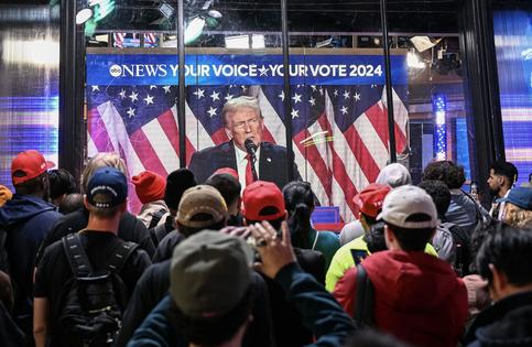 New York City residents watch Donald Trump speak as votes are tallied for the presidential election on Nov. 6, 2024.
              Fatih Aktas/Anadolu via Getty Images