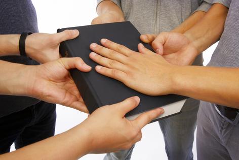 Holding the Holy Bible and taking promises. Dreamstime/TCA