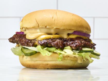 Learn how to cook thin, crispy smash burgers on the stovetop with gooey American cheese and buttery toasted buns. (Alex Lepe/TCA)