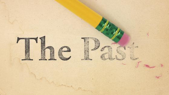 Erasing The Past. Close up of a yellow pencil erasing the words, 'The Past' from old, yellowed paper. Dreamstime/TCA