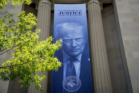 A banner featuring President Trump on the outside of the DOJ building in Washington, D.C. Andrew Harnik/Getty Images