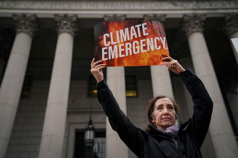 NEW YORK, NY - OCTOBER 22: Environmental activists rally for accountability for fossil fuel companies outside of New York Supreme Court on October 22, 2019 in New York City. Tuesday is the first day of a trial where New York's attorney general is taking on ExxonMobil in a landmark case that accuses the oil corporation of misleading investors about the companys financial risks due to climate change. (Photo by Drew Angerer/Getty Images)