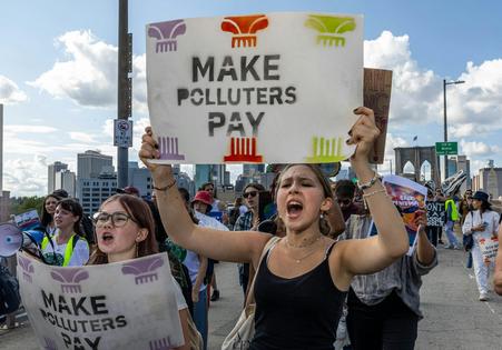 Across the U.S., people are calling for companies to pay for the damage they have done to the environment. Alex Kent/AFP via Getty Images