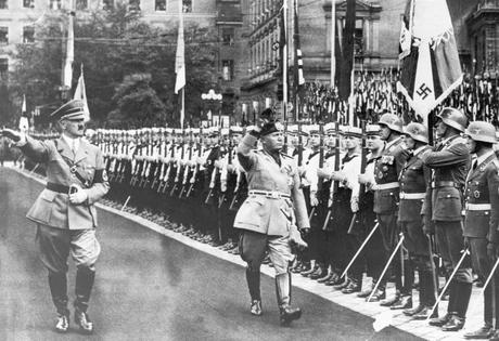 Hitler and Mussolini salute Nazi troops in 1937. Bettmann/Getty Images