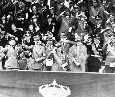 Benito Mussolini, Adolf Hitler, King Victor Emmanuel III and Queen Elena watch a parade held in Hitler’s honor in 1938. Behind them, from left: Joachim von Ribbentrop, Galeazzo Ciano, Joseph Goebbels and Rudolf Hess.
Bettmann/Getty Images