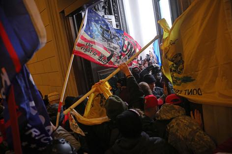 WASHINGTON, DC - JANUARY 06: Protesters supporting U.S. President Donald Trump break into the U.S. Capitol on January 6, 2021 in Washington, DC. Congress held a joint session today to ratify President-elect Joe Biden's 306-232 Electoral College win over President Donald Trump. Pro-Trump protesters entered the U.S. Capitol building during demonstrations in the nation's capital. (Photo by Win McNamee/Getty Images)