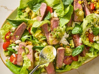 This flavorful salad with seared strip steak and fresh veggies is ready in 30 minutes. (Alex Lepe/TCA)
