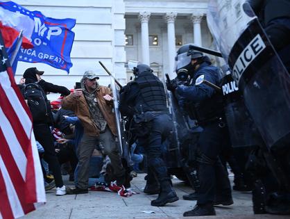 Trump supporters clash with police and security forces, as they storm the U.S. Capitol in Washington, D.C., on Jan. 6, 2021. (Brendan Smialowski/AFP/Getty Images/TNS)