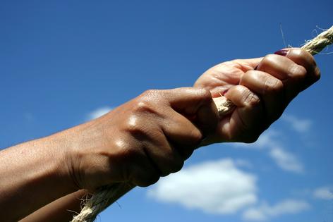 Woman pulling rope, strength. Dreamstime/TCA