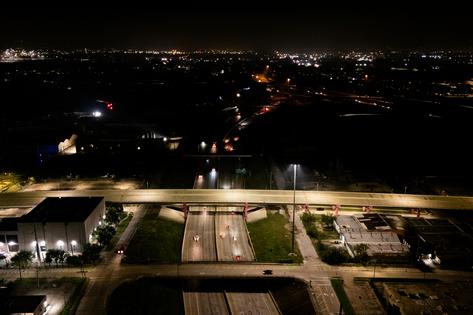 Residential neighborhoods without power are shown beyond lit highways on July 12, 2024, in Houston, Texas. Millions of residents around the Houston metropolitan and costal areas continue braving the aftermath of Hurricane Beryl's destruction. Weather reports are indicating a stall in recovery efforts as chances of storms increase throughout the region. (Brandon Bell/Getty Images/TNS)
