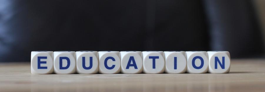 Education letters cube wordings on wood table. Dreamstime/TCA