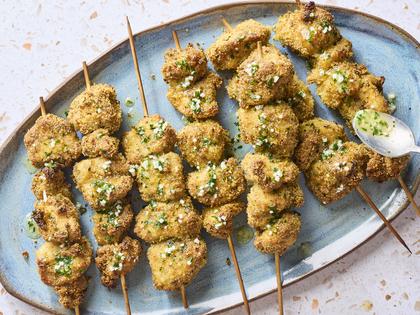 Skewers of marinated chicken are tossed with a combination of Italian breadcrumbs and Parmesan cheese, then drizzled with garlic butter sauce. (Alex Lepe/TCA)