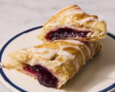 A sweet, jammy filling made with frozen cherries is surrounded by flaky puff pastry and drizzled with a sweet stir-together glaze. (Christopher Testani/TCA)