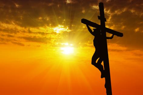 Silhouette Jesus Christ crucifixion on cross at sunset. Dreamstime/TCA