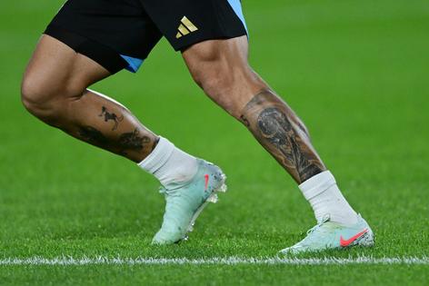 The leg tattoos on midfielder Leandro Paredes of Argentina. Marcelo Endelli/Getty Images