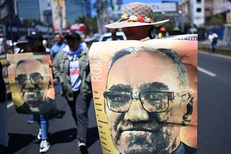 People protest against the emergency regime imposed by El Salvador's President Nayib Bukele's government since March 2022 during a march to commemorate the 46th anniversary of the assassination of Salvadoran Archbishop Oscar Arnulfo Romero (19171980) in San Salvador on March 24, 2026. (Photo by Marvin RECINOS / AFP via Getty Images)