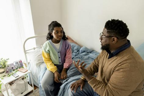 Compared to the previous generation, fathers now are more likely to be involved in their teens' lives.  The Good Brigade/DigitalVision via Getty Images