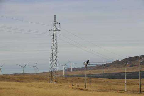 Workers set up power transmission lines.
Sanggay Tashi, CC BY-ND