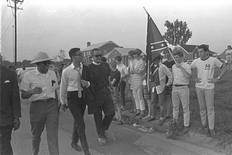 James Meredith, left, passes white spectators after he began a 225-mile walk from Memphis, Tenn., to Jackson, Miss., on June 6, 1966.
              AP Photo