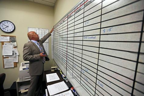 A court interpreter checks the day's schedule of assignments. AP Photo/Brennan Linsley