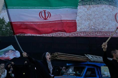 A woman waves an Iranian flag in Islamic Revolution Square in Tehran, Iran, on June 14, 2026.
AP Photo/Vahid Salemi