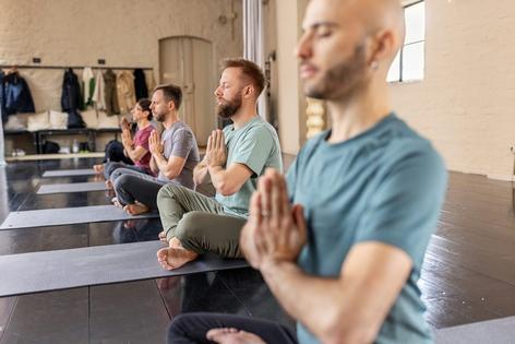 Many yoga classes end with the instructor explaining 'namaste' as 'the divine in me bows to the divine in you.' Luis Alvarez/DigitalVision via Getty Images