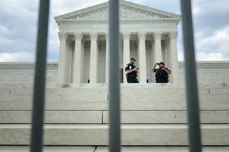 Police stand watch in front of the Supreme Court building on June 18, 2026, in Washington before the court handed down three decisions.
Chip Somodevilla/Getty Images