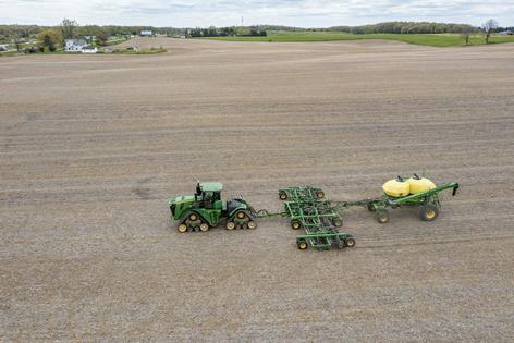 A farmer in Michigan spreads liquid fertilizer on a field. Jim West/UCG/Universal Images Group via Getty Images