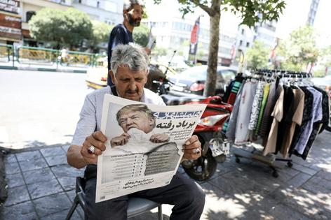A man reads a newspaper bearing an image of the U.S. president and a headline that reads ‘Gone with the wind’ in Tehran on June 18, 2026.
              AFP via Getty Images