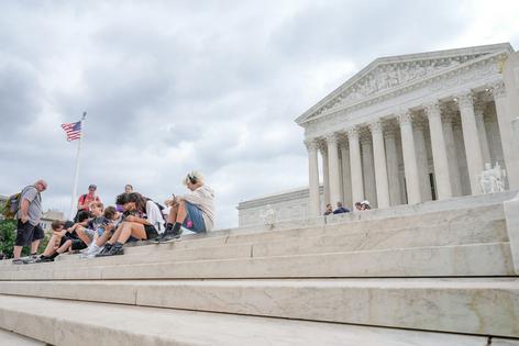 Visitors sit on the steps of the U.S. Supreme Court in Washington on June 8, 2026.
              AP Photo/Mariam Zuhaib