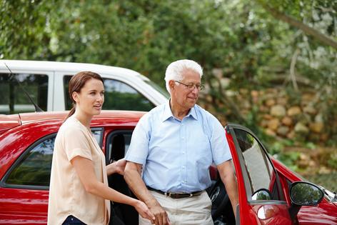 Daughter taking care of elderly father. Dreamstime/TCA