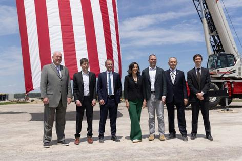 Michigan Gov. Gretchen Whitmer, center, has been criticized for participating in this photo op at the construction site for a new data center in her state.
              Related Digital via Planet Detroit