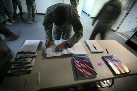 A service member fills out an absentee ballot in Afghanistan in 2008. Overseas voters often rely on mail-in ballots. AP Photo/Rafiq Maqbool