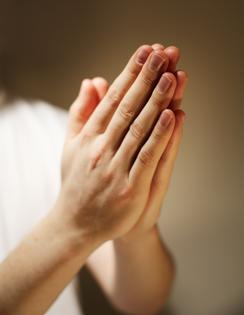 Hands clasped in a prayer. Dreamstime/TCA