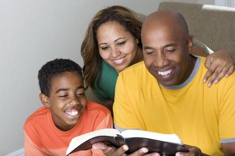 Family reading Bible. Dreamstime/TCA