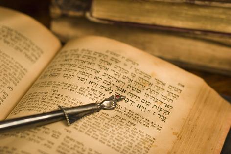 Old Hebrew Bible and pointer. Dreamstime/TCA