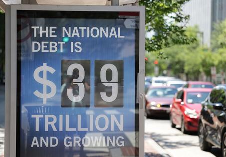 WASHINGTON, DC - JUNE 12: A Peterson Foundation bus stop sign displays the national debt on June 12, 2026 in Washington, DC. (Photo by Tasos Katopodis/Getty Images for the Peter G. Peterson Foundation)