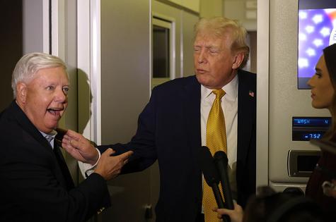 IN FLIGHT - JANUARY 04: U.S. President Donald Trump (R) and U.S. Sen. Lindsey Graham (R-SC) speak to the media aboard Air Force One enroute to Washington, DC on January 04, 2026. Trump is returning to the White House after giving the order for the United States law enforcement to capture Venezuelan President Nicolás Maduro and his wife. (Photo by Joe Raedle/Getty Images)