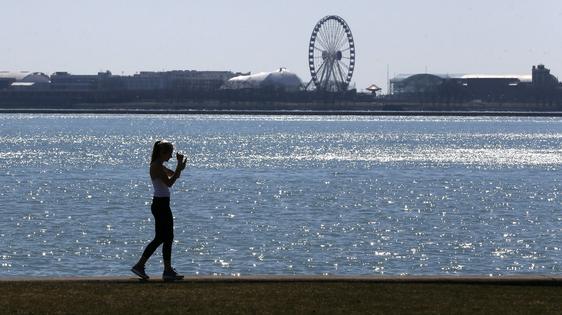 A person walks the trail along Lake Michigan at Chicago's North Avenue Beach. AP Photo/Charles Rex Arbogast