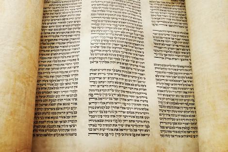 Torah scroll opened for reading. 400-year-old Torah scroll opened to Exodus 34. Dreamstime/TCA