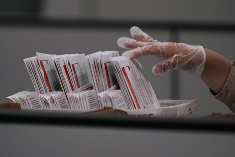 A worker inspects a ballot the day after California's primary election at the Los Angeles County Ballot Processing Center on June 3, 2026. Jae C. Hong/AP Photo
