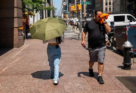 People try to stay cool on the sweltering streets of Manhattan during a heat wave in July 2025. Spencer Platt/Getty Images