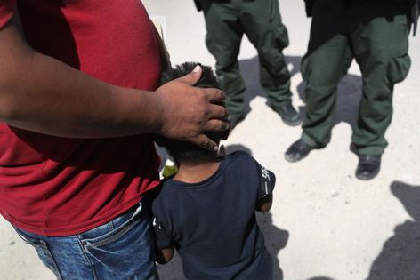 MISSION, TX - JUNE 12:  U.S. Border Patrol agents take a father and son from Honduras into custody near the U.S.-Mexico border on June 12, 2018 near Mission, Texas. The asylum seekers were then sent to a U.S. Customs and Border Protection (CBP) processing center for possible separation. U.S. border authorities are executing the Trump administration's zero tolerance policy towards undocumented immigrants. U.S. Attorney General Jeff Sessions also said that domestic and gang violence in immigrants' country of origin would no longer qualify them for political-asylum status.  (Photo by John Moore/Getty Images)