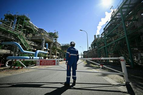 A worker stands at a TotalEnergies refinery in northwestern France. Lou Benoist/AFP via Getty Images