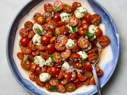 A bright salad with cherry tomatoes, fresh basil, and tiny pearls of mozzarella, tossed together with a zippy dressing. (Ryan Liebe/TCA)