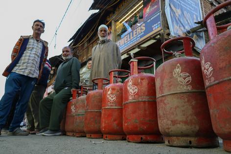Customers stand with empty cooking-gas cylinders in Srinagar, India, waiting to be able to refill them. Firdous Nazir/NurPhoto via Getty Images