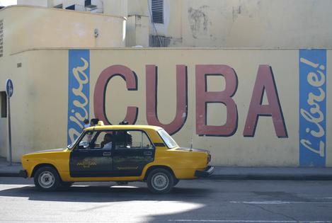 Cuba Sign. Cuba libre sign on wall with taxi, Havana, Cuba. Dreamstime/TCA